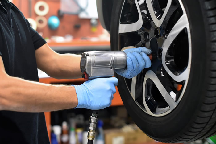 Technician working on a vehicle wheel